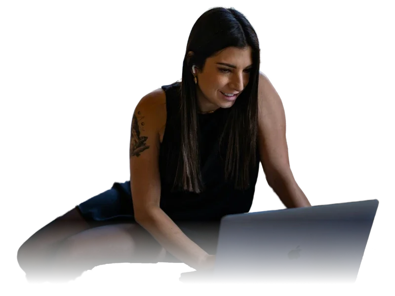 A woman smiling at her laptop